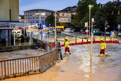 Swiss inspect the damage after sudden storms flood roads, halt air traffic in Geneva