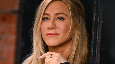 Jennifer Aniston teaming basic black flip flops with a chic blazer proves why your pair should be more than just beachwear