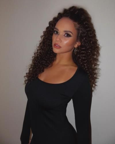 Madison Pettis Stuns In Bold Black Photoshoot With Curly Hair