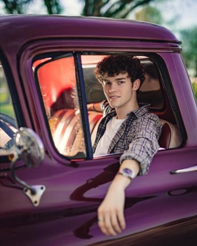 Hayden Summerall Showcasing Style In A Purple Luxury Vehicle