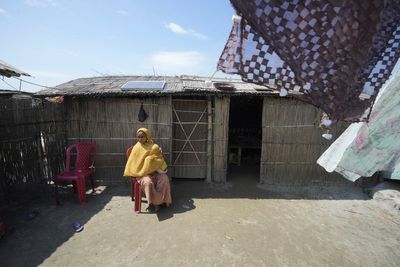 Indian mother delivers baby on boat as her river island is inundated by floodwaters