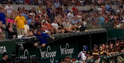 A Rangers fan nearly fell into the Padres dugout trying to catch a foul ball, gets called a ‘clown’