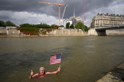 An American swims in Paris' Seine River before the Olympics despite contamination concerns