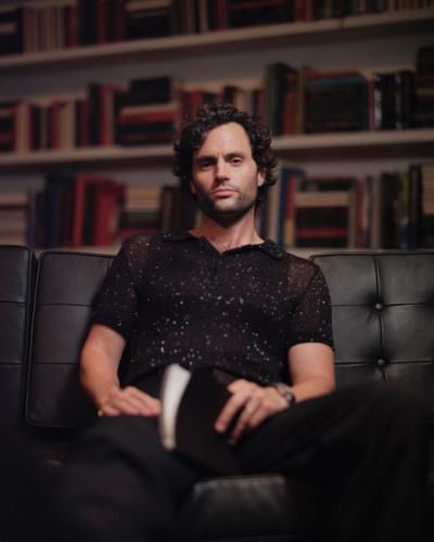 Penn Badgley Strikes A Stylish Pose Surrounded By Books