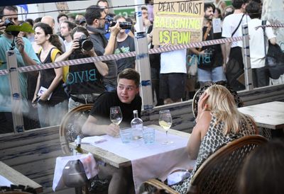 Barcelona residents are so fed up with tourism they’re squirting visitors with water guns as they try to enjoy their meals