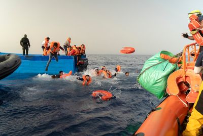 Armed bandits interrupt a rescue of migrants in the Mediterranean off Libya, an aid group says