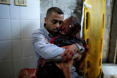 A boy in Gaza was killed by an Israeli airstrike. His father held him and wouldn't let go