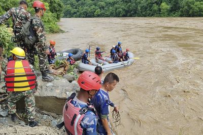 More than 60 people missing after two buses swept into river in Nepal