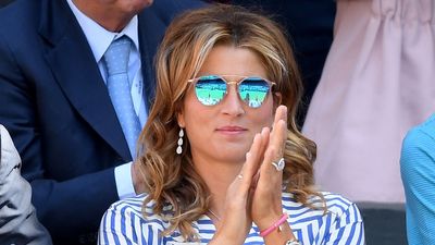 Mirka Federer kept it casual at Wimbledon in distressed white shorts and a striped blue shirt