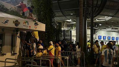 WATCH: Police evict ticketless people as fans climb through vents to enter stadium ahead of Copa America final