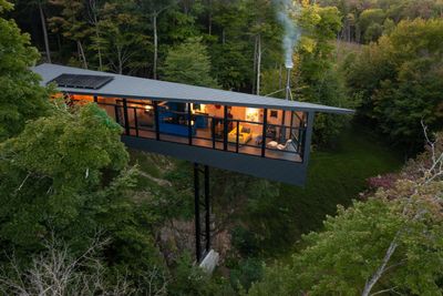 A dramatic new lakeside cabin in the Canadian wilderness rises above the trees