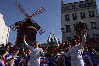 Artists, chefs, garbage collector among hundreds carrying the Olympic torch through Paris