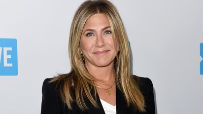 Jennifer Aniston's combo of white trainers, turned-up jeans and a smart blazer should be in your summer style rotation