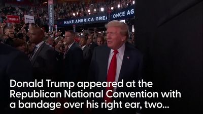 Donald Trump appears with bandage over ear at Republican National Convention to cheers after assassination attempt