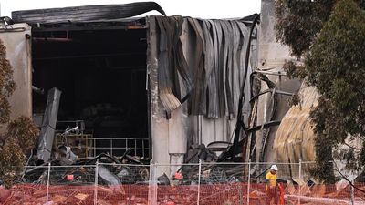 Crews continue to battle hot spots after factory blaze