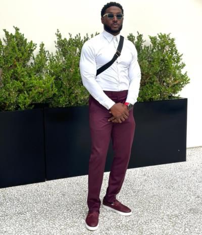 Reggie Bush Sports Chic White Shirt With Burgundy Pants Ensemble