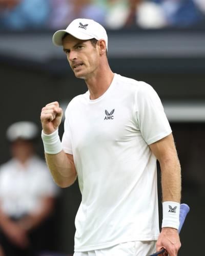 Andy Murray Triumphs In Tennis Match In Stylish White Attire