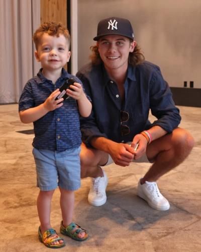 NHL Star Jack Hughes Beaming With Joy Beside Child