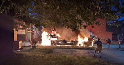 Riot breaks out in Leeds as police car flipped and double-decker bus set on fire