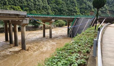 11 dead and dozens missing after a highway bridge in China crumbles in flooding and heavy storms