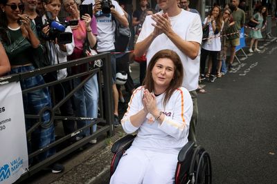 A Lebanese photojournalist, wounded in Israeli strike, carries Olympic torch to honor journalists