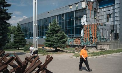 ‘I felt the water tremble’: Ukraine’s Olympic swimmers train as bombs fall