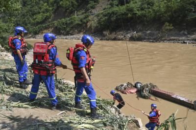 China Floods: 25 Dead, Dozens Missing In Bridge Collapse