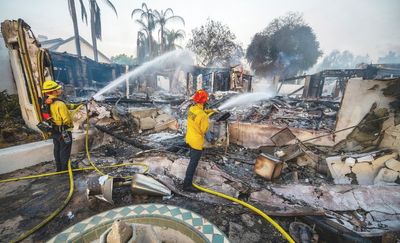 Wildfires plague the West amid a scorching heat wave. Homes burn in Southern California