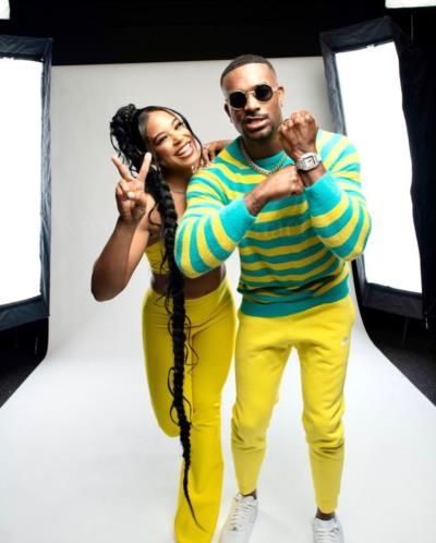 Bianca Belair And Husband Coordinate Stylish Yellow And Blue Outfits.