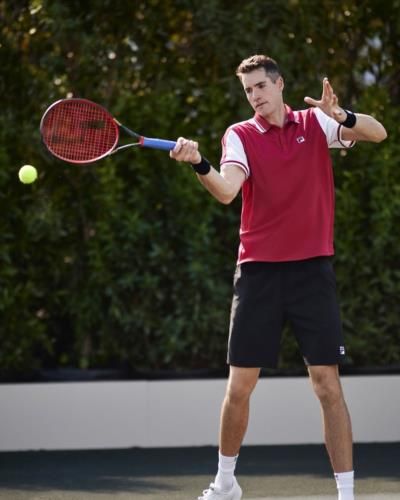 Professional Tennis Player John Isner Showcases Skills On Court