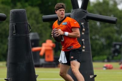 Joe Burrow Practicing In Orange Shirt And Black Shorts