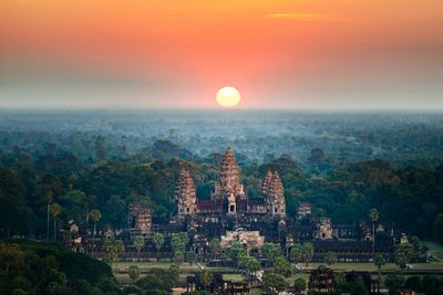 Fierce storm topples tree at Cambodian Angkor temple complex, killing 1 and damaging statues