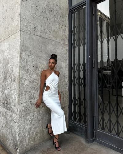 Stylish White Outfit: Kedist Deltour's Fashionable Wall Pose