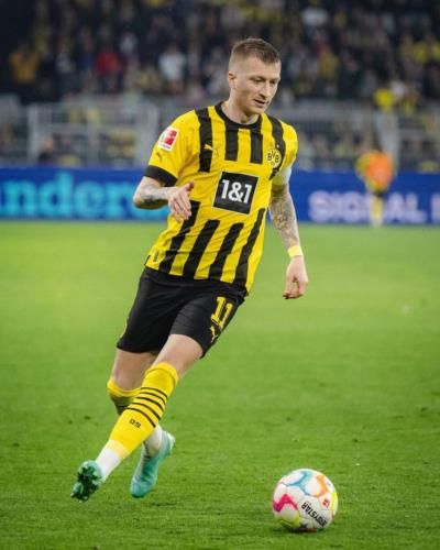 Marco Reus Showcasing Skills In Iconic Black And Yellow Jersey