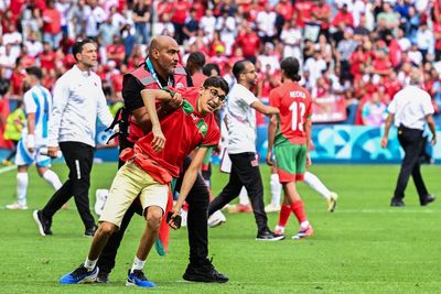 Fans storm pitch and throw bottles as Argentina v Morocco descends into chaos to kick off Olympics