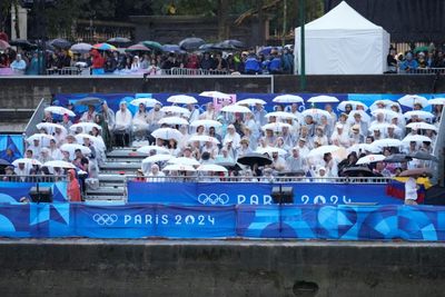 Rainy Paris Olympic Parade Dampens Many Spectators' Spirits