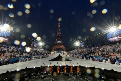 AP PHOTOS: Paris glitters in the rain for ambitious Olympic opening ceremony