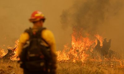 Firefighters battle California’s seventh largest wildfire on record as thousands under threat