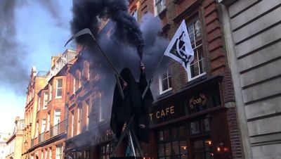 Eight arrests as fake crude oil thrown and 'grim reaper' appears at Extinction Rebellion occupation