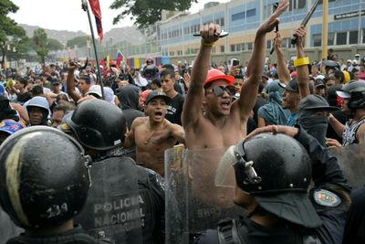 Armed civilians appear to shoot at Venezuelans protesting against the government