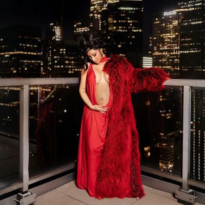 Cardi B Reveals Her Third Pregnancy in a Belly-Baring Red Gown and Fur Coat