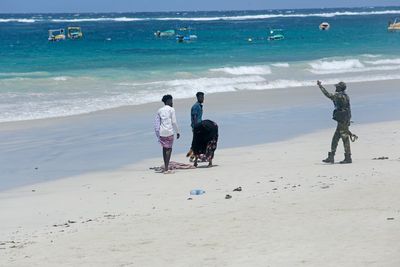 Hundreds gather at Somalia beach to condemn attack that killed 37 and demand stronger security