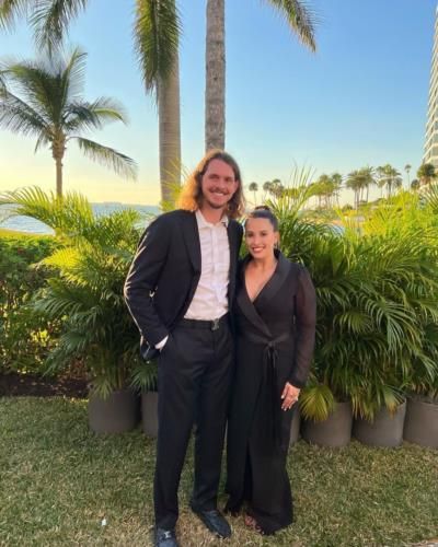 Elegant Couple Embraces In Coordinated Black Outfits