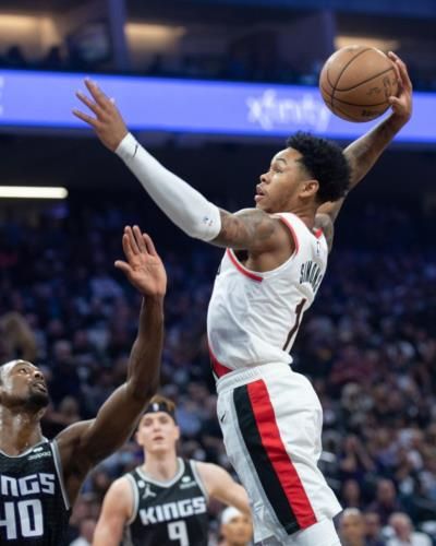Anfernee Simons: Dynamic Player Demonstrating Skill And Teamwork On Court