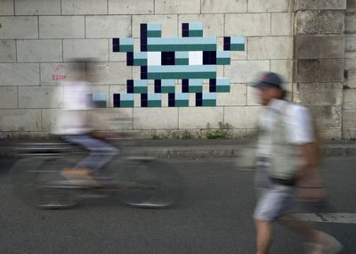 Mystery Paris street artist 'Invader' glues up new work to celebrate Olympics and delight fans