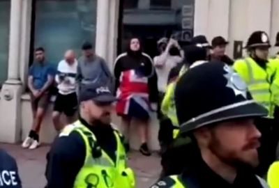 Four protestors hide behind police amid huge Brighton anti-racist demonstration