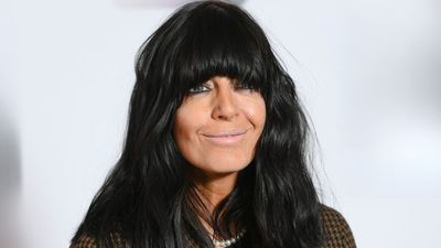 Claudia Winkleman nails effortless chic in an oversized dark denim shirt and classic white tee at Wilderness Festival