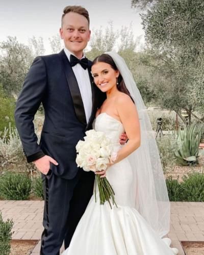 Elegant Couple Embraces In Timeless Wedding Moment