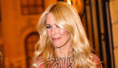 Claudia Schiffer’s vibrant red maxi skirt, beige long-sleeved top and raffia handbag is an unbeatable chic summer ensemble