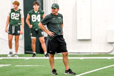 MSU football head coach Jonathan Smith plays tennis with Michigan State tennis star Ozan Baris